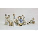 Lladro figure of girl with doves, a Lladro boy reclining with bird, another Lladro figure of boy