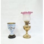 Victorian oil lamp with pink and white variegated shade and brass body and a glass-mounted and