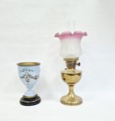 Victorian oil lamp with pink and white variegated shade and brass body and a glass-mounted and