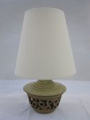 20th century lamp with studio pottery-style pierced base and cream shade together with a 20th