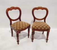 Eight Victorian walnut dining chairs, each with trefoil hoop back, stuffover seat, on turned