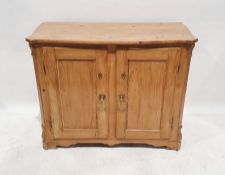 Victorian pine cupboard, the shaped top with two cupboard doors enclosing shelves, on bracket