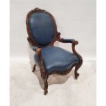 Victorian armchair in blue upholstered seat, back and armrests, heavily carved frame, serpentine-