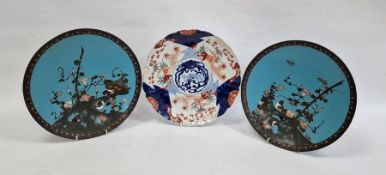 Pair Japanese cloisonné enamel chargers and convolvulus flowers against a blue sky background,