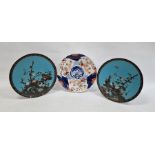 Pair Japanese cloisonné enamel chargers and convolvulus flowers against a blue sky background,