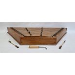 Elm based hammer dulcimer of trapezoidal form (106 x 11 x 44 cm) with two hammers and a tuner