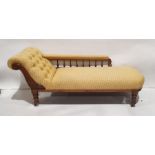 Victorian chaise longue in yellow upholstery, carved shewwood frame, on turned supports to brown