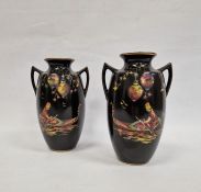 Pair 20th century pottery vases, ovoid and two handled, black ground and decorated with figures in