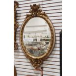 Oval bevel edged mirror in moulded egg and dart frame, 94cm x 55cm