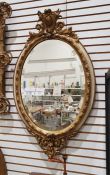 Oval bevel edged mirror in moulded egg and dart frame, 94cm x 55cm