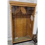 Oak and glazed shop display cabinet on plinth base, 112cm x 193cm