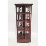 Late 19th/early 20th century revolving library bookcase, the serpentine top with mounded edge and