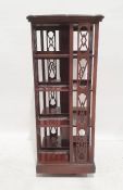 Late 19th/early 20th century revolving library bookcase, the serpentine top with mounded edge and