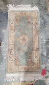 20th century Chinese green ground super wash rug 138 x 71 cm