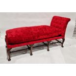 Queen Anne-style day bed upholstered in red, on cabriole legs united by turned and block stretchers
