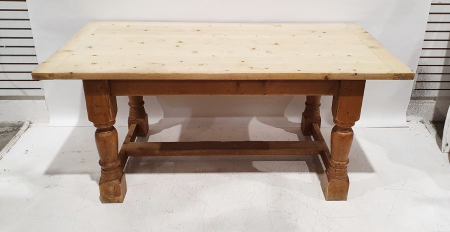 20th century pine dining table, the plank top with pleated end supports, on turned and block