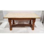 20th century pine dining table, the plank top with pleated end supports, on turned and block