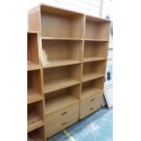 Pair of modern oak shelves with rounded top and bottom corners, four shelves above two drawers,