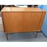 Mid century modern teak cabinet, the rectangular top above tambour door, on cylindrical tapering