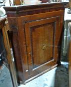 George III inlaid oak and mahogany wall-hanging corner cabinet having stepped and cavetto