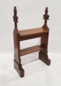 Antique oak bookcase formed from pew ends, each terminating in carved fleur-de-lys, having two