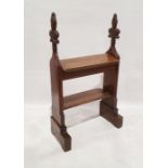 Antique oak bookcase formed from pew ends, each terminating in carved fleur-de-lys, having two