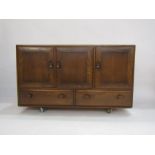 Ercol elm sideboard with oval dished handles, 3 cupboard doors above 2 drawers on castors, 75.5cm