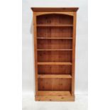 20th century pine open bookcase with moulded cornice above assorted shelves, on plinth base, 197.5cm