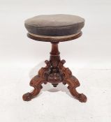 Victorian mahogany circular piano stool, on turned and carved base and ogee carved legs