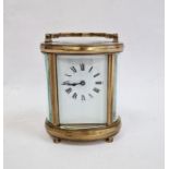 20th century brass and glass carriage clock with oval body, Roman numerals to the dial, 11cm high