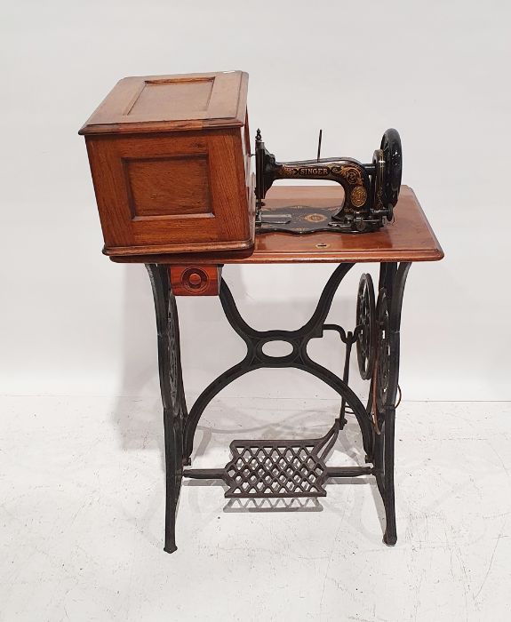 Vintage Singer sewing machine on trestle base Condition ReportMechanism appears to work when wheel