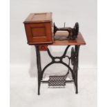 Vintage Singer sewing machine on trestle base Condition ReportMechanism appears to work when wheel