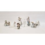 Lladro porcelain group of child seated with dog and puppies, Lladro figure of a girl grooming a dog,