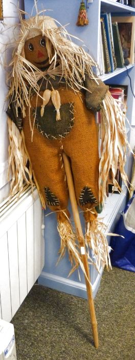 Scarecrow stuffed with dried reeds and mounted on a bamboo pole