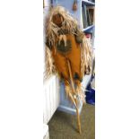 Scarecrow stuffed with dried reeds and mounted on a bamboo pole