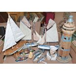 Various wooden models of boats and yachts and a wooden model of a lighthouse