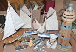 Various wooden models of boats and yachts and a wooden model of a lighthouse