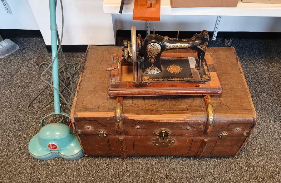 A Jones sewing machine, a Hoover floor polisher and a trunk.