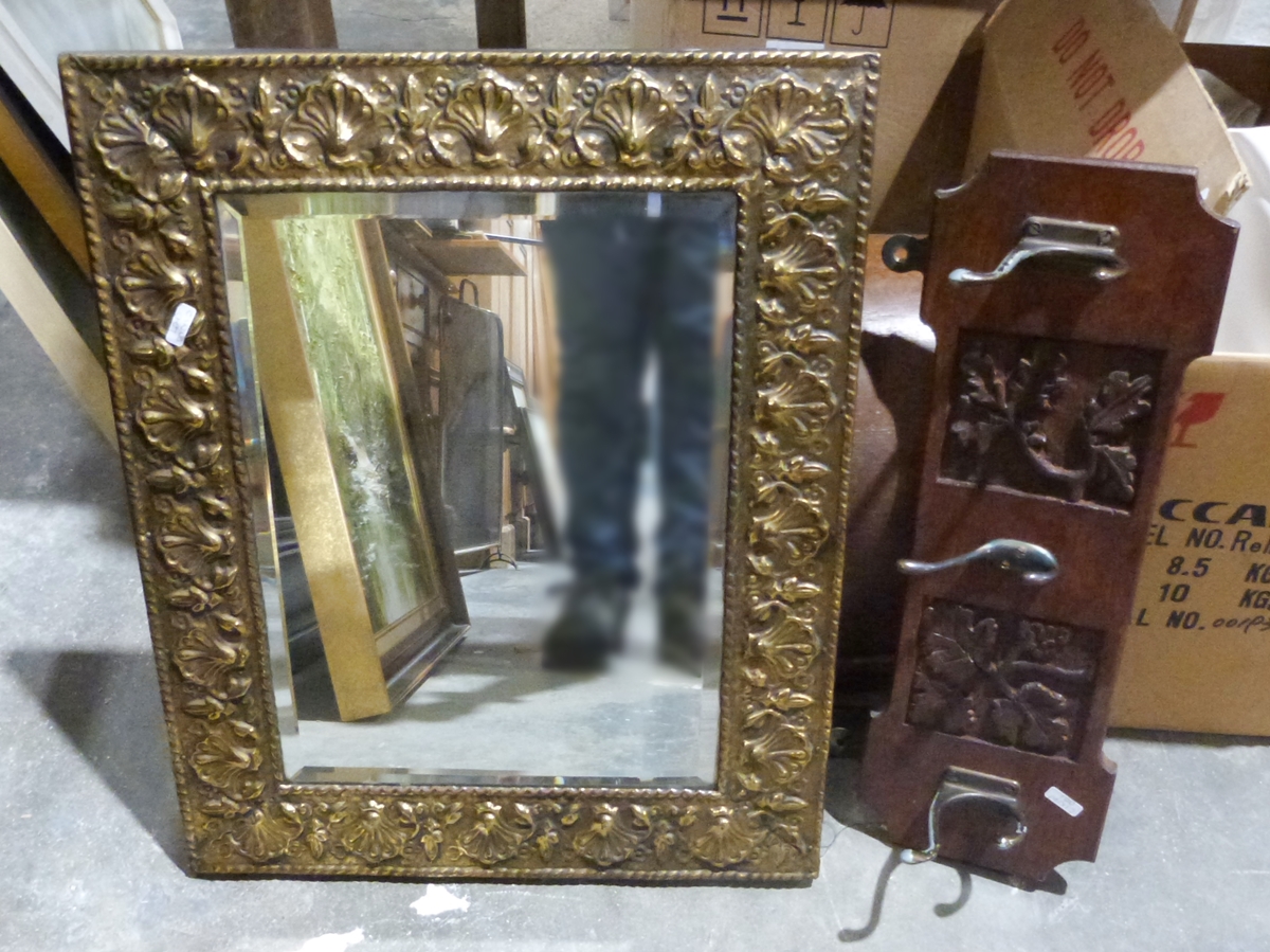 Wall mirror with embossed brass frame and a carved oak wall-hanging coat rack (2)
