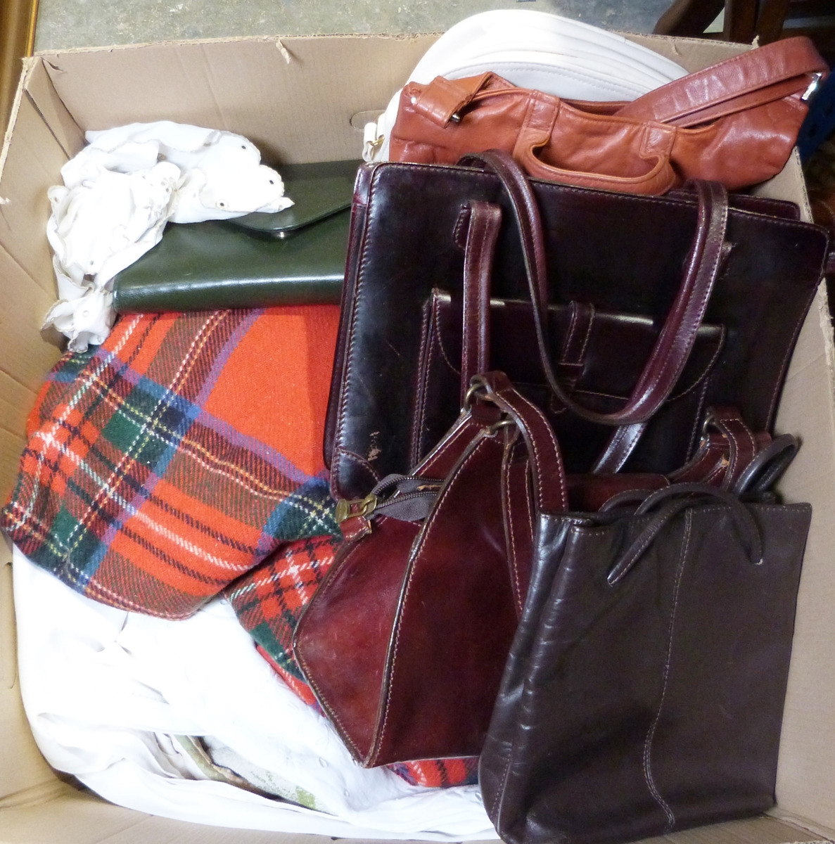 Two boxes of assorted linen and various leather handbags (2 boxes)