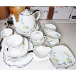Heathcote china part tea service in white with blue and yellow floral spray decoration, black