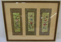 Three Chinese embroidered panels framed as one, depicting birds, flowers, insects within a border,