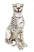 Large ceramic cheetah, 75cm tall approx., a pair of cranberry glass table lamps with matching