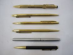 Mont Blanc stainless steel rollerball pen, four gilt metal Mont Blanc pens including a multi-