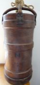 WWII brown leather artillery shell carrier with carry handles crossing over at the top, ribbed