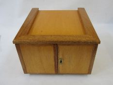 Stained wood table top coin cabinet of 12 drawers enclosed by two doors, approx. 34cm w x 22cm h x