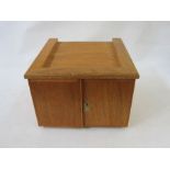 Stained wood table top coin cabinet of 12 drawers enclosed by two doors (three drawers missing),