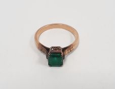 Gold-coloured metal ring set with an emerald-coloured stone, not hallmarked, probably 9ct gold
