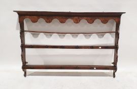 18th century oak wall-hanging plate rack, the moulded cornice above two shelves, iron hooks, 91cm