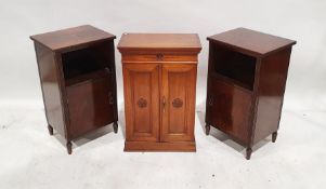 Edwardian mahogany two-door cabinet with carved floral motif, the doors opening to reveal shelves